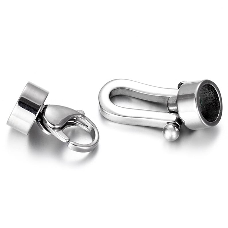May include: Two silver metal clasps for jewelry making. One clasp is a hook and loop style, the other is a toggle clasp.