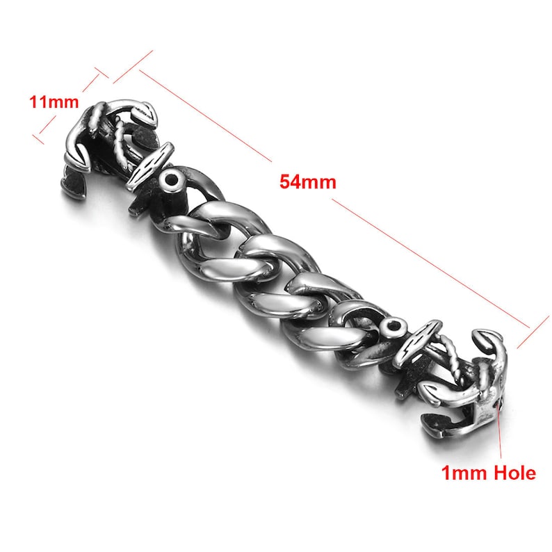 May include: Silver-toned stainless steel bracelet with two anchor-shaped clasps. The bracelet is 5.4 cm long and 1.1 cm wide. The clasp has a 1 mm hole.