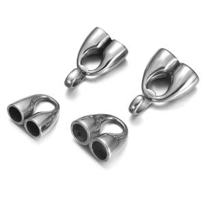 May include: Four shiny, silver-colored metal jewelry findings. Each finding has two openings and a loop. The findings are designed for jewelry making and crafting projects.