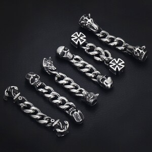 May include: A set of eight silver charm bracelet links featuring various designs, including skulls, crosses, and animal heads.
