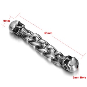 May include: Silver skull charm with a 53 mm long chain and a 2 mm hole. The skull is 9 mm wide.