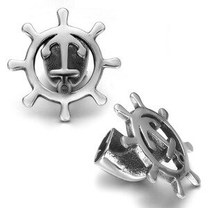 May include: Two silver-coloured nautical-themed charms. Each charm features a ship's wheel design with an anchor in the centre. The charms are made of a shiny, metallic material and are set against a white background.