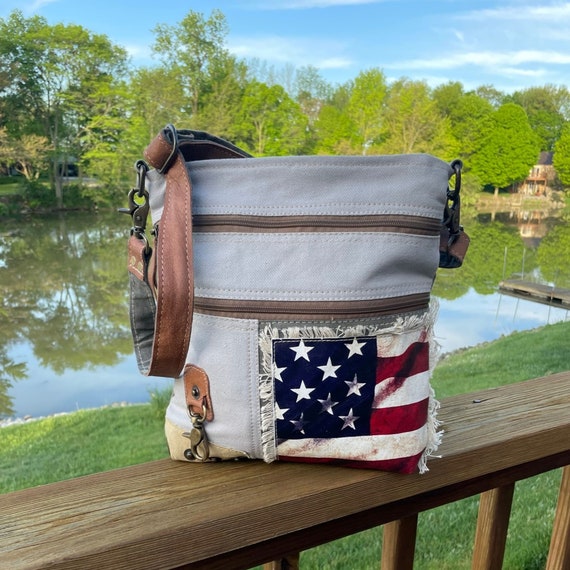 Leather crossbody bag with all-over embossed eagle