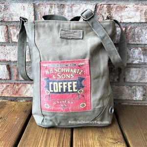May include: A green canvas tote bag with a vintage coffee advertisement patch. The patch features the text "W.H. Schwartz & Sons Coffee Halifax N.S."