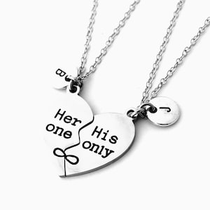 May include: Two silver necklaces with heart-shaped pendants that fit together. The pendants say "Her one" and "His only" with an infinity symbol between them.