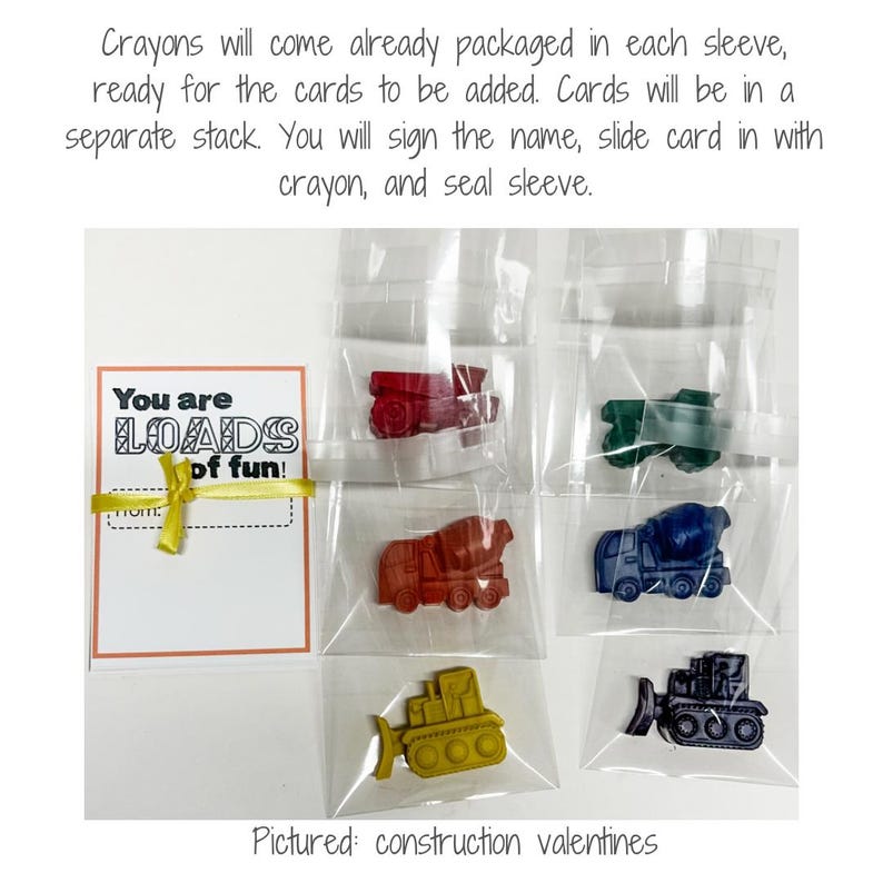 May include: Construction-themed Valentine's Day crayons in clear plastic sleeves. Each crayon is shaped like a different vehicle, including a cement mixer, bulldozer, and dump truck. A card with the text "You are LOADS of fun!" is included.