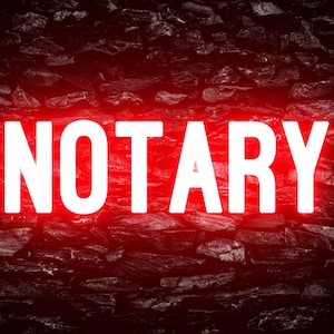 May include: A white neon sign with the word "NOTARY" in all caps against a dark red brick wall background.