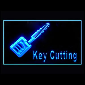 Puede incluir: Señal de neón azul con una silueta de llave y el texto "Key Cutting" en blanco.