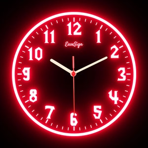 May include: A round, red-lit wall clock with white numerals and hands against a dark background. The clock face displays the time, with the brand name "EaseSign" in the center. The clock has a modern, illuminated design.