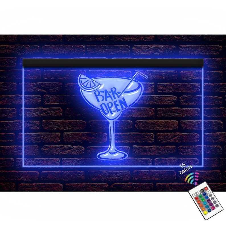 May include: A neon sign featuring a blue cocktail glass design with the text "BAR OPEN". The sign is framed in blue and set against a brick wall. A remote control with 16 colour options is included.