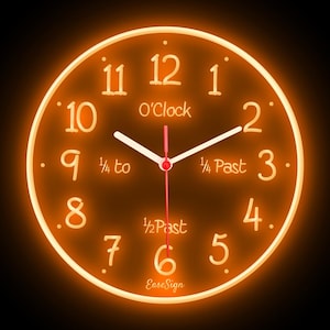May include: An illuminated orange clock with white hands and numerals. The clock face includes the text "O'Clock", "1/4 to", "1/4 Past", and "1/2 Past". The brand name "EaseSign" is printed at the bottom.