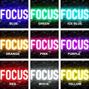 May include: Nine different colored neon signs with the word "FOCUS" in white letters. The colors are blue, green, ice blue, orange, pink, purple, red, white, and yellow.