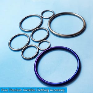 May include: A collection of circular metal rings in various sizes. The rings are silver and one is a vibrant purple with blue hues. The text at the bottom reads "Pure Titanium Invisible Clothing Accessory".