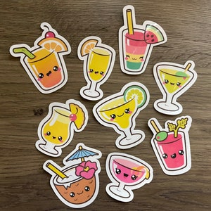 May include: Ten colorful stickers featuring cartoon drinks with smiling faces. The stickers are shaped like the drinks they represent, including a pineapple, a watermelon, a glass of juice, a cocktail, and a coconut.