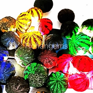 May include: A collection of colourful, round, decorative objects with a variety of patterns. The objects are made of a smooth, shiny material and have a slightly textured surface. Some of the objects are striped, while others have a more abstract design. The objects are arranged in a random pattern on a white surface.