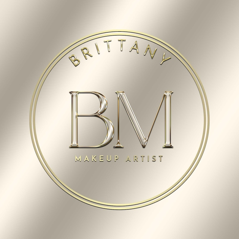 May include: Gold circular logo with the text "Brittany" and "Makeup Artist" around the outside. The initials "BM" are in the center of the logo.