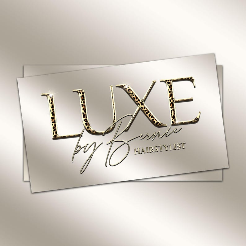 May include: A business card design featuring the text "LUXE by Bernie HAIRSTYLIST". The word "LUXE" is in gold with a leopard print pattern. The other text is in a cursive font, with a gold color. The background is a gradient of light beige.