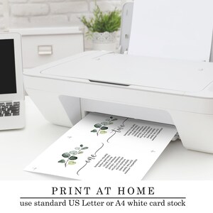 May include: A white printer with a sheet of paper emerging from it. The paper is divided into two sections with the words "one" and "two" written on them. The paper also features a floral design with green leaves. The text "PRINT AT HOME use standard US Letter or A4 white card stock" is at the bottom of the image.