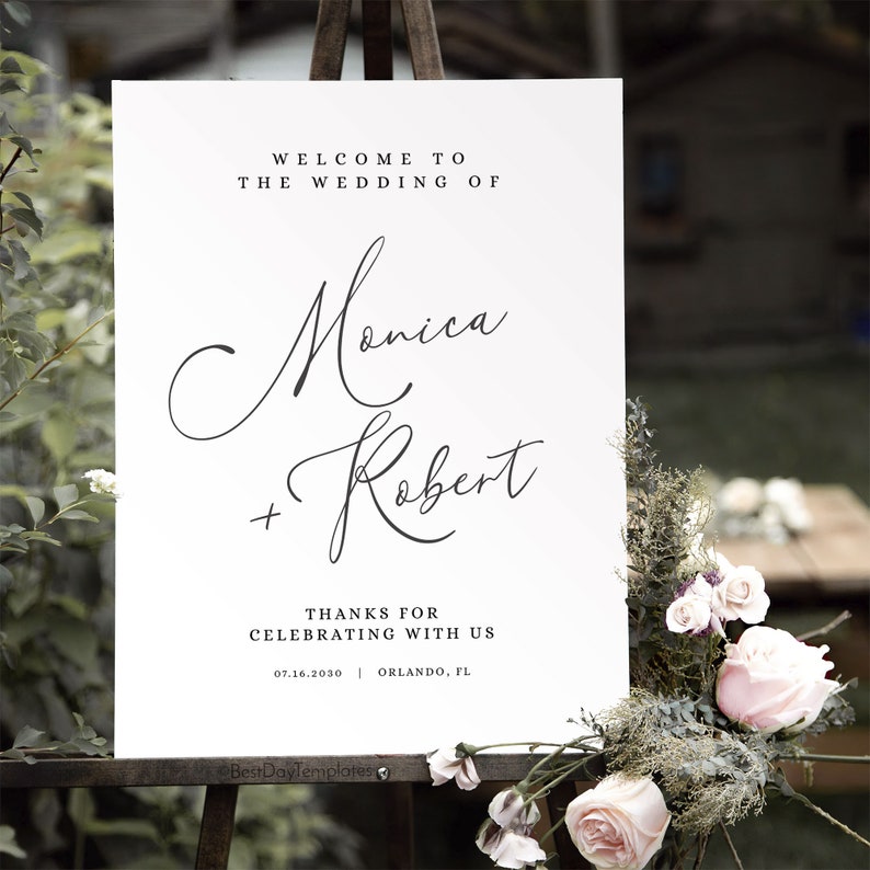 May include: White wedding welcome sign with black calligraphy text that reads "Welcome to the wedding of Monica + Robert" and "Thanks for celebrating with us 07.16.2030 Orlando, FL".