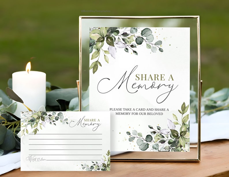 Peut inclure: Une pancarte dor&eacute;e avec un fond blanc et un motif de feuillage vert. La pancarte indique "Partager un souvenir" et "Veuillez prendre une carte et partager un souvenir pour notre bien-aim&eacute;". Il y a une carte plus petite avec le m&ecirc;me motif et le texte "Partager un souvenir".
