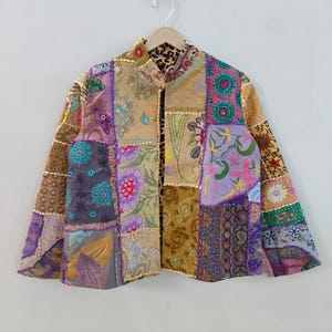 May include: A patchwork jacket with a variety of floral and geometric patterns in shades of purple, gold, and green. The jacket is made of multiple fabric squares sewn together, creating a unique and colorful design. The collar has a leopard print.