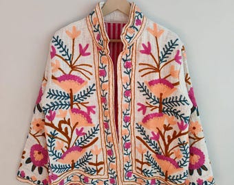 May include: Cream-colored embroidered jacket with a floral design in shades of pink, orange, and brown. The jacket has a mandarin collar and is lined with a striped fabric. The embroidery features detailed floral patterns.