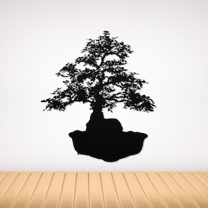 May include: Black silhouette of a bonsai tree with a thick trunk and many branches. The tree is mounted on a black rock base.