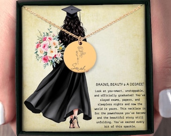 May include: Gold-colored necklace with a round pendant featuring a floral design and the name "Sarah." The pendant hangs from a delicate chain. The image includes a graduation-themed illustration and text that reads "BRAINS, BEAUTY & A DEGREE!"