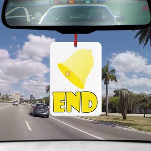 May include: A yellow car air freshener with a bell and the word "END" in yellow letters.
