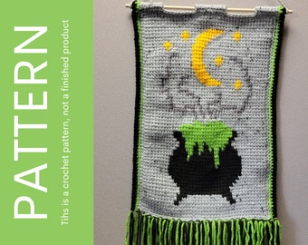 May include: A crochet wall hanging featuring a black cauldron, green potion, a yellow crescent moon, and yellow stars on a grey background. The hanging has a green and black fringe.