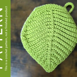 May include: A green crocheted leaf-shaped pot holder with a loop for hanging.