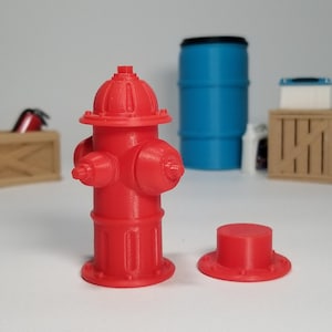 May include: A red fire hydrant with a removable cap. The hydrant is made of plastic and is about 4 inches tall.
