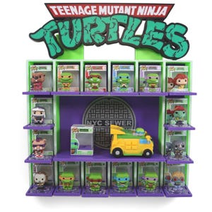 May include: A Teenage Mutant Ninja Turtles display case featuring various Funko Pop figures of the characters. The display is green and purple, with the words "Teenage Mutant Ninja Turtles" at the top. A yellow and green turtle van is also present.