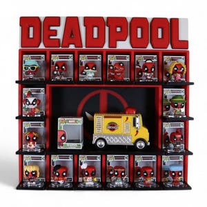 May include: A red and black wooden display shelf with the word DEADPOOL in large red letters at the top. The shelf contains sixteen boxed Deadpool Funko Pop figures and one yellow Chimichanga food truck toy on the central middle shelf.