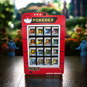May include: A red Pokedex display case with the word "POKEDEX" in white. The case holds 16 small, boxed figurines of various Pokemon characters. The bottom of the case reads "KANTO REGION" and "ONLINE".