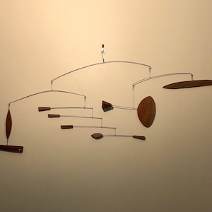 One of a kind!!  Artistic mobiles hand made from Black Walnut! Customizable shapes and sizes.