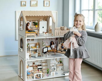 May include: A three-story wooden dollhouse featuring an open-front design with multiple rooms, including a kitchen, living area, and bedrooms. The structure is made of light-colored wood with arched doorways and contains various miniature furniture pieces.