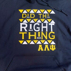 May include: Navy blue hooded sweatshirt with a white and yellow graphic print that reads "Did the Right Thing... A.L.P.H.A."