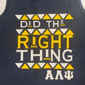 May include: A navy blue tank top with a white and yellow design. The design features a pattern of triangles and the text "Did the right thing A".