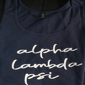May include: A navy blue tank top with the white text "alpha lambda psi" printed on the front.