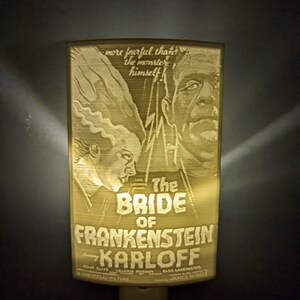 May include: A vintage movie poster for the film "The Bride of Frankenstein" featuring Boris Karloff. The poster is yellowed and has a distressed look. The text on the poster reads "more fearful than the monster himself!" and "The Bride of Frankenstein starring Boris Karloff".