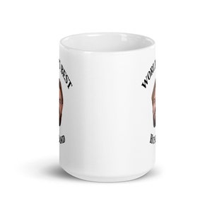 May include: White ceramic mug with a black and white image of a man's face and the text "World's Best Husband" on the mug.