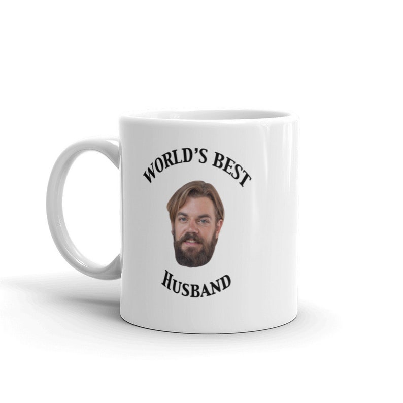 May include: White ceramic mug with a black graphic that says "World's Best Husband" and a photo of a man with a beard.
