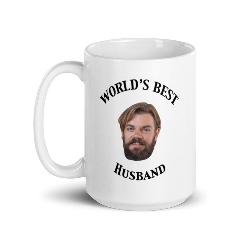 May include: White ceramic mug with a black graphic that says "World's Best Husband" and a photo of a man with a beard.