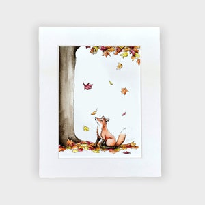 May include: A watercolor painting of a fox sitting under a tree with falling autumn leaves. The fox is looking up at the leaves, which are shades of red, orange, and yellow. The tree trunk is brown and the background is white.