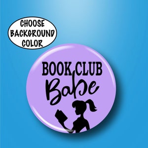May include: Purple button with the text "BOOK CLUB Babe" in black lettering. A silhouette of a person reading a book is below the text.