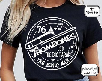 May include: Black t-shirt with a white circle design featuring a trombone, the text "76 Trombones Led The Big Parade The Music Man", and musical notes.