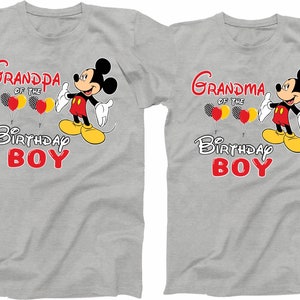 May include: Two grey t-shirts with a cartoon image of Mickey Mouse. The text on the shirts reads "Grandpa of the Birthday Boy" and "Grandma of the Birthday Boy".