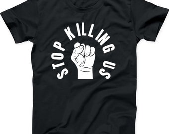 May include: Black t-shirt with a white fist raised in the air and the text "STOP KILLING US" in a circle around the fist.