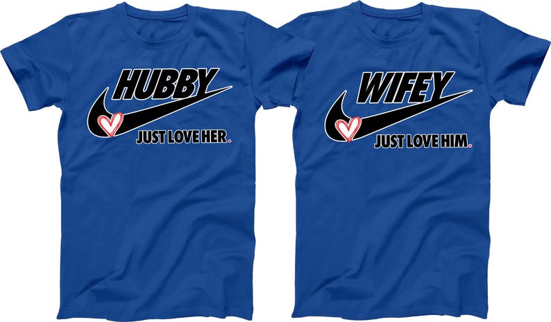 May include: Two blue t-shirts with a black swoosh and a heart design. One shirt says "Hubby Just Love Her." The other shirt says "Wifey Just Love Him."